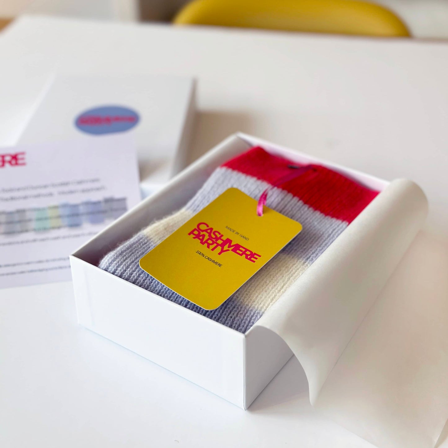 100% cashmere socks in gift box with Cashmere Party swing ticket. Handmade socks in red light blue and cream stripes.