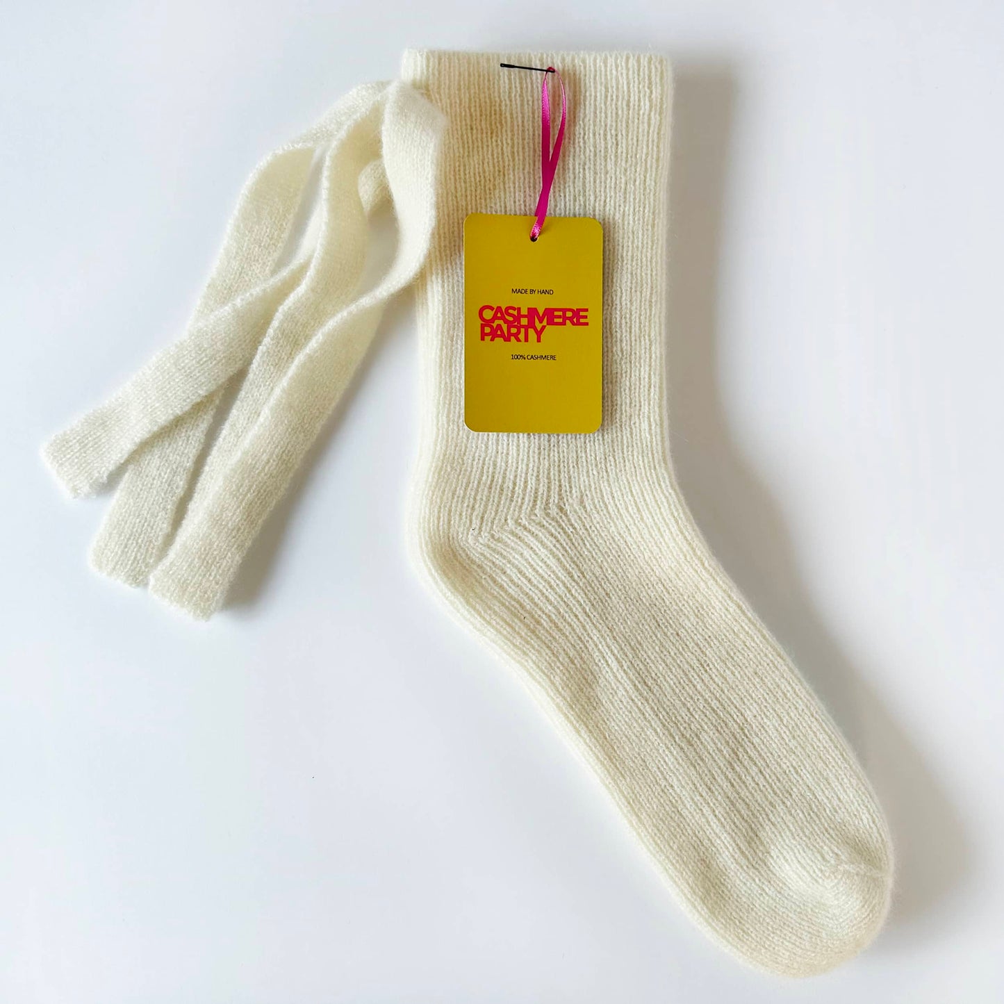 Flat image of chunky pure cashmere handmade socks by Cashmere Party with branded swing ticket.