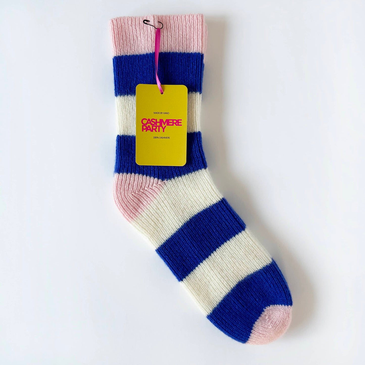 100% cashmere socks by Cashmere Party.  Flat image of handmade sock on table.  Blue and cream modern stripe fun socks.  Pink heel and toe.  With cashmere party swing ticket.
