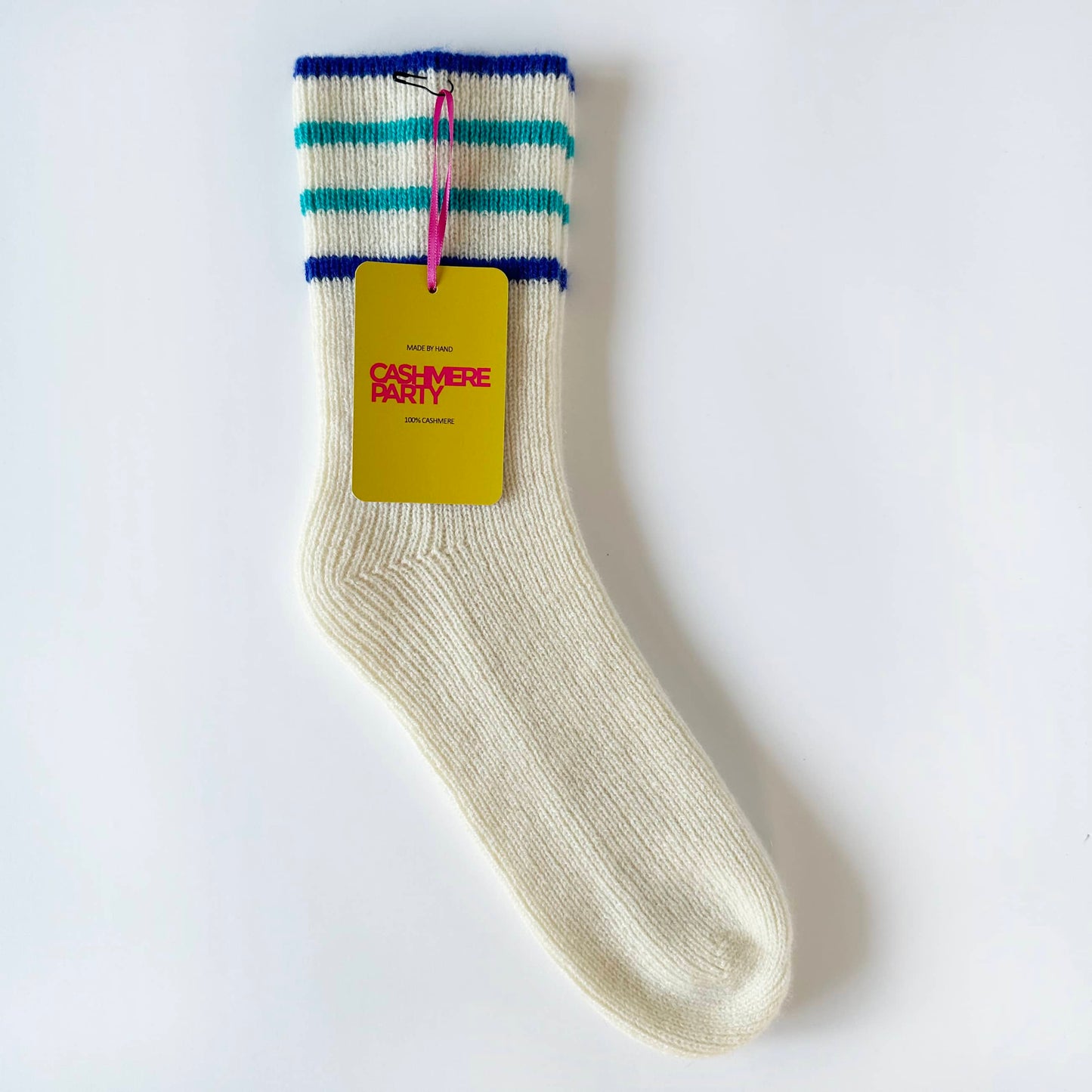 Flat image of 100% cashmere socks by Cashmere Party. Handmade cashmere sport socks with blue sport stripes laying flat on a table with a branded swing ticket.