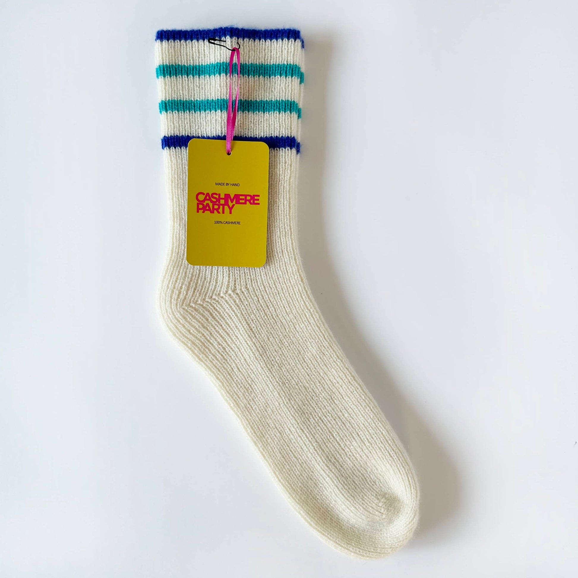 Flat image of 100% cashmere socks by Cashmere Party.  Handmade cashmere sport socks with blue sport stripes laying flat on a table with a branded swing ticket.