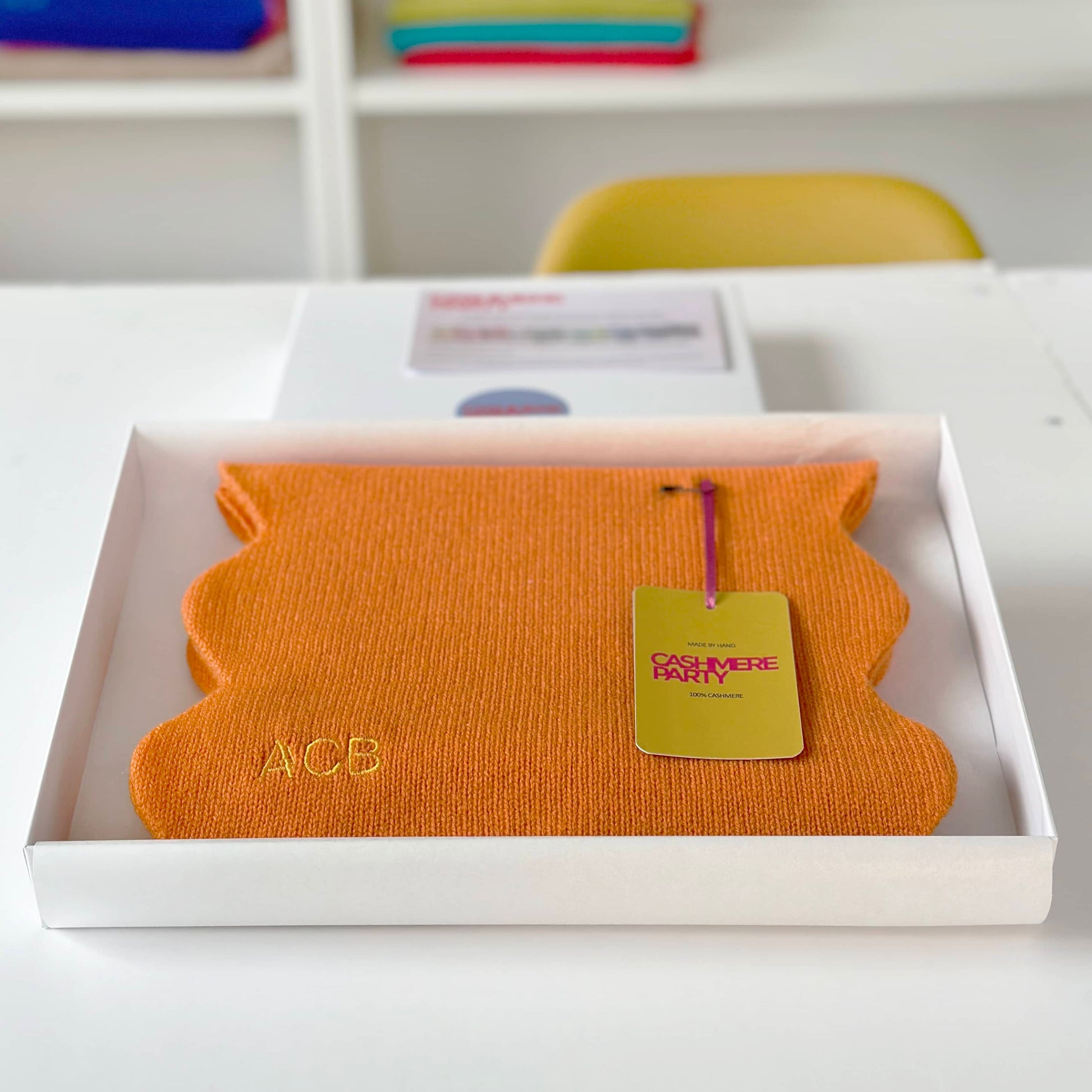 Orange cashmere scarf with scallop edges by Cashmere Party.  Scarf folded in gift box with swing ticket.  Personalised cashmere scarf with scallop edges.