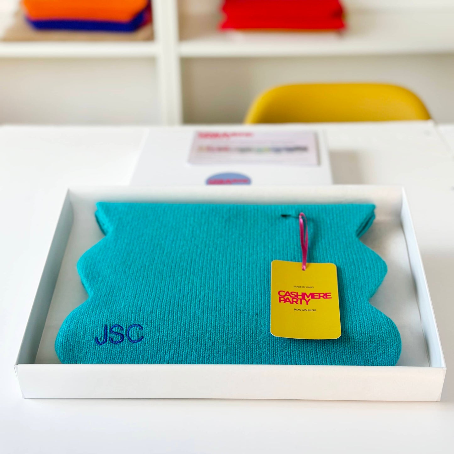 Turquoise cashmere scarf in gift box with branded swing ticket.  Handmade cashmere knitted scarf with scallop edge.  Modern fun bright cashmere scarf.