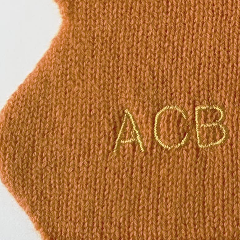 Close up of embroidered personalisation of cashmere scarf.