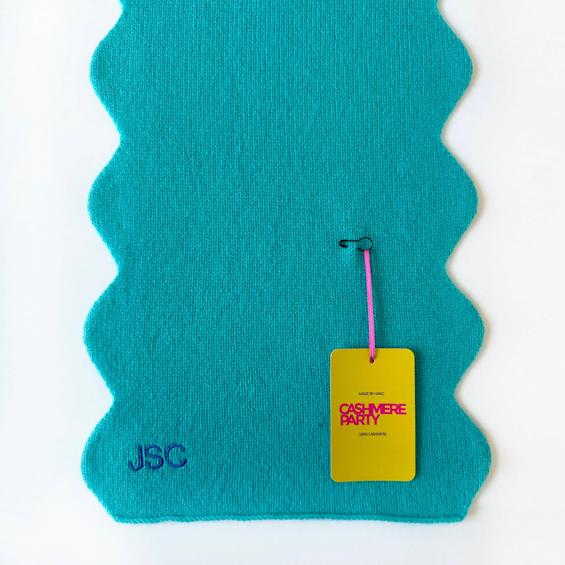 Scallop edge cashmere scarf by Cashmere party with branded swing ticket.  Personalised with embroidered initials in turquoise colour.