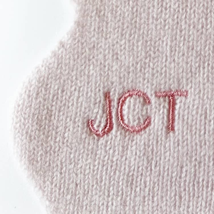 Embroidered initials personalisation close up of cashmere scarf.