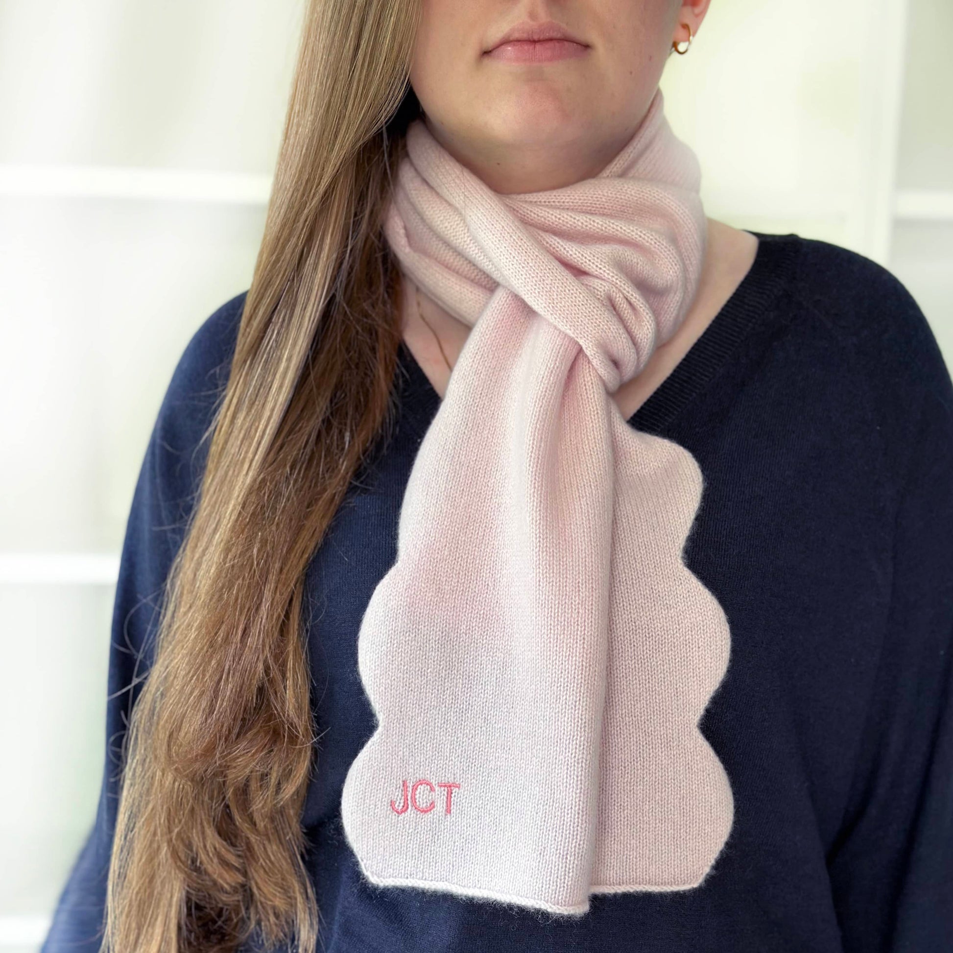 Light pink soft warm cashmere scarf with scallop edges and personalisation by Cashmere Party on woman.