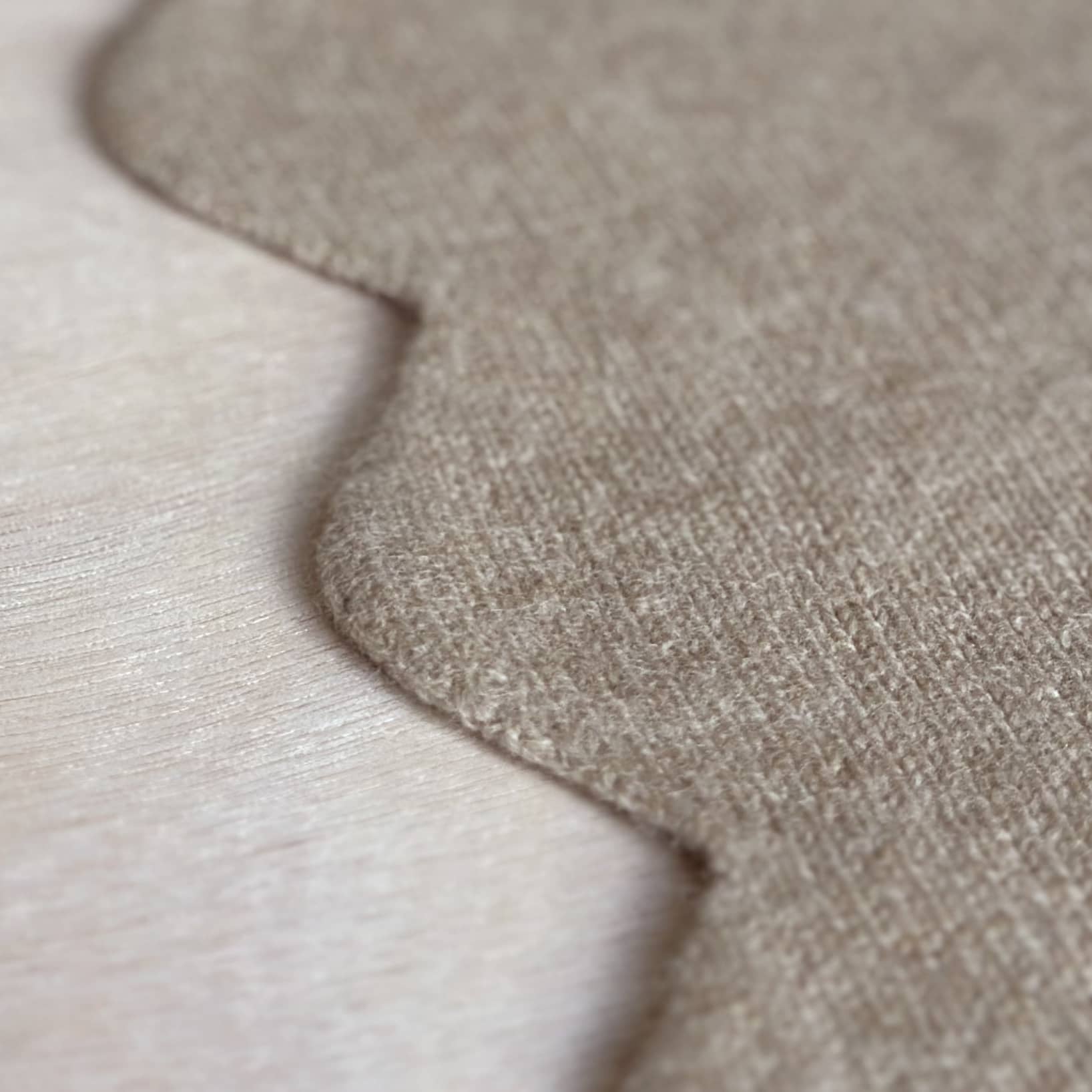 Close up detail of scalloped edge baby blanket in pure cashmere.
