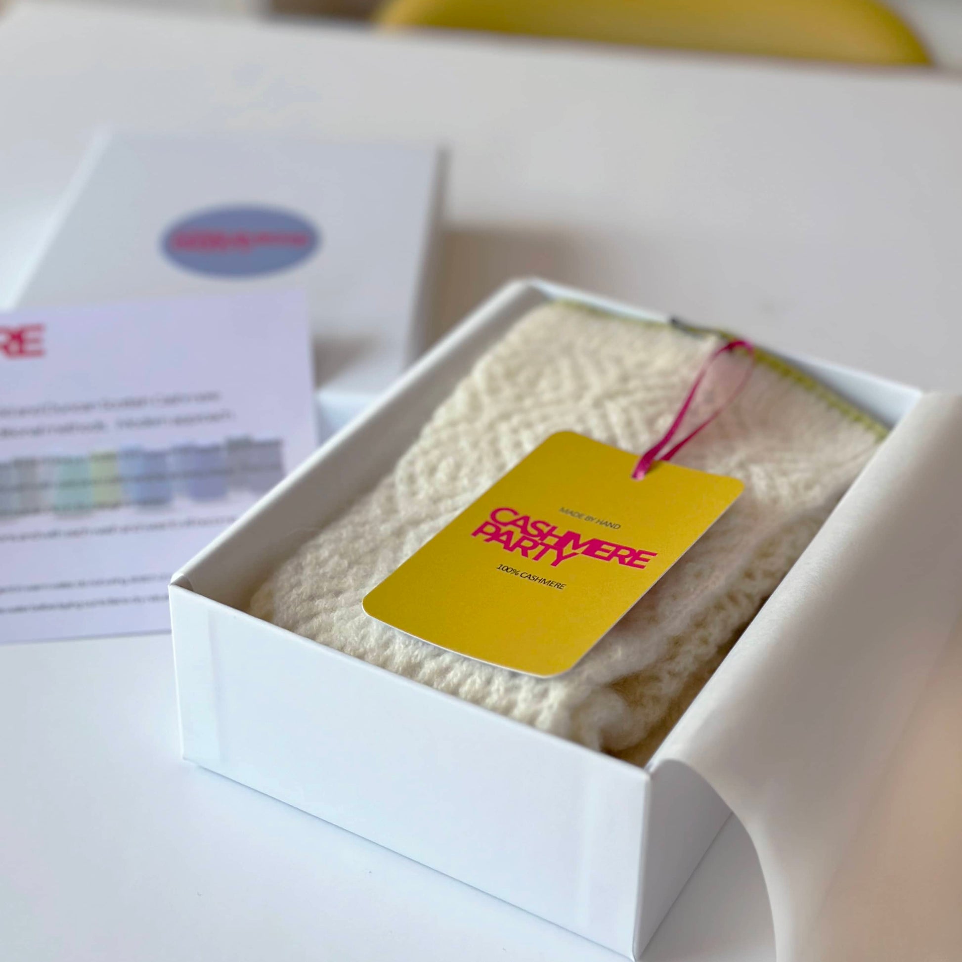 100% cashmere knitted lace socks in gift box with branded Cashmere Party swing ticket.