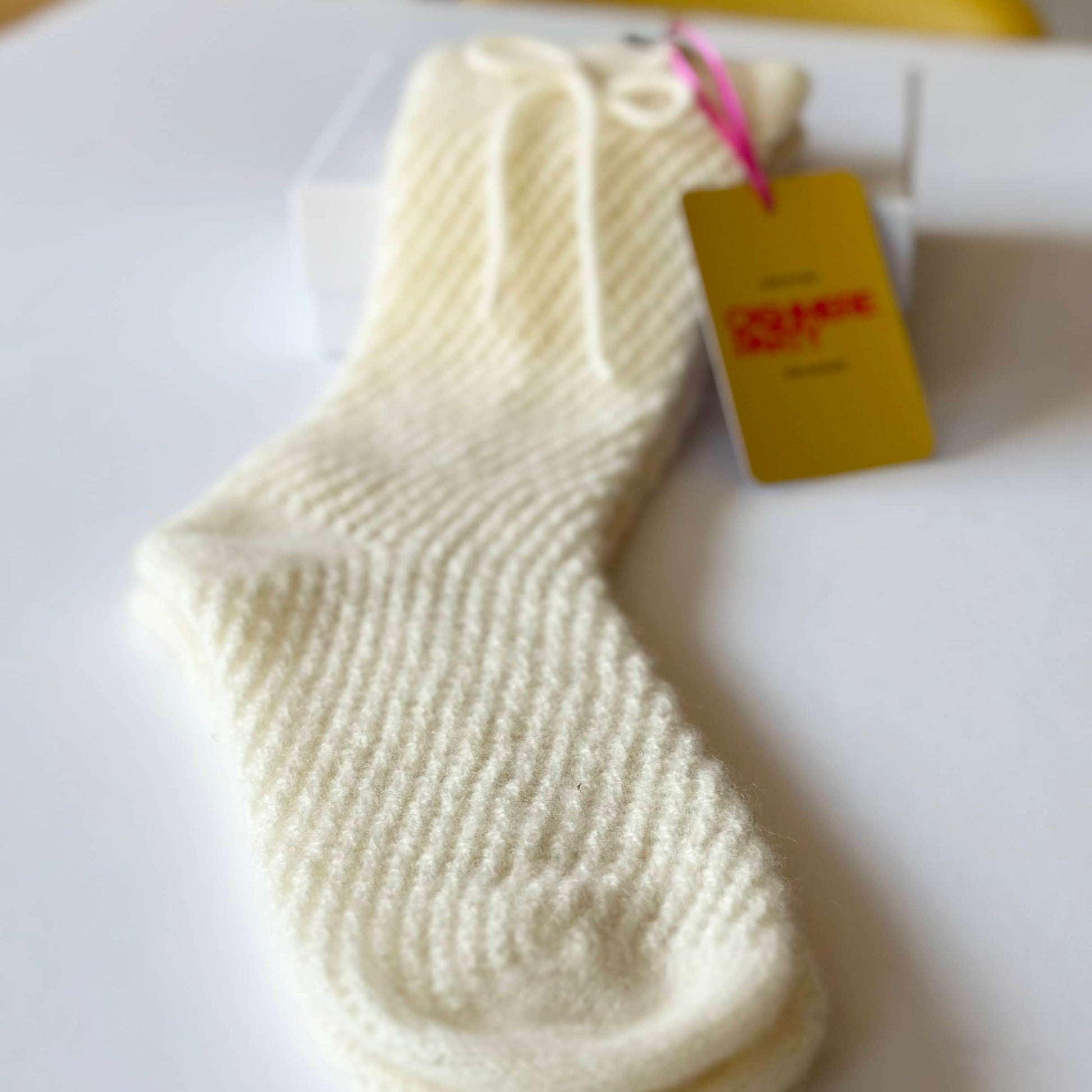 Close up of pure cashmere knitted lace mesh sock by Cashmere Party.  Handmade lace cashmere sock.