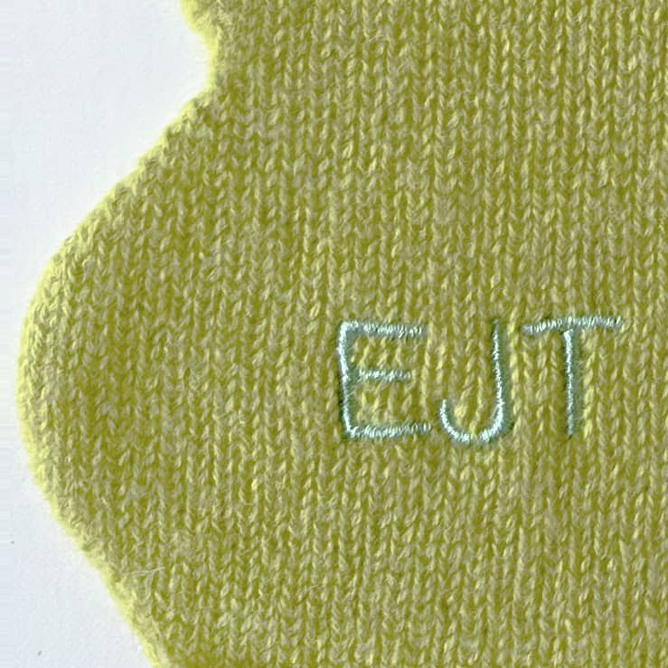 Close up of embroidered personalisation of cashmere scarf.