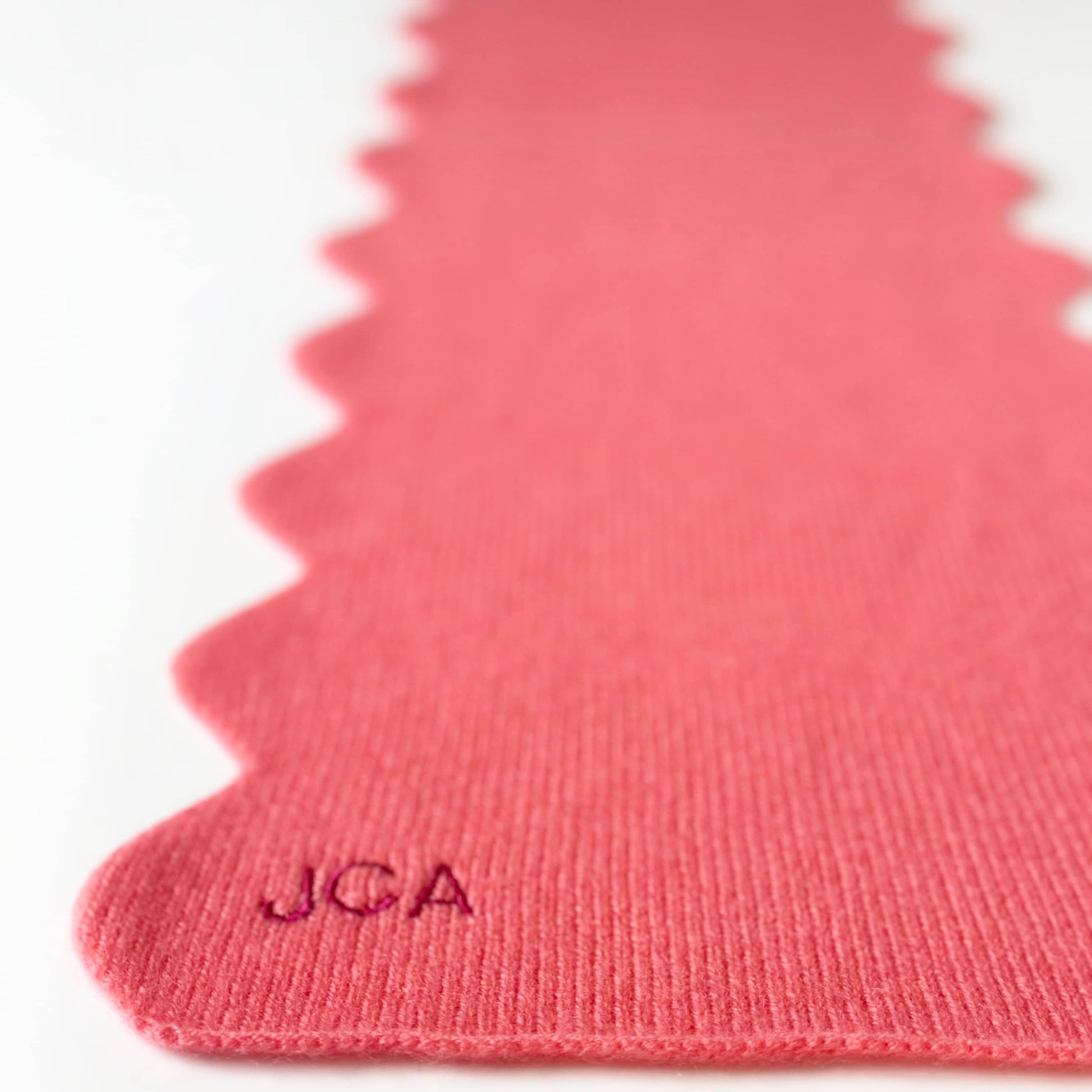 100% cashmere scarf with scallop edges in coral colour and personalisation.  Cashmere party handmade cashmere scarf with scallop edges.