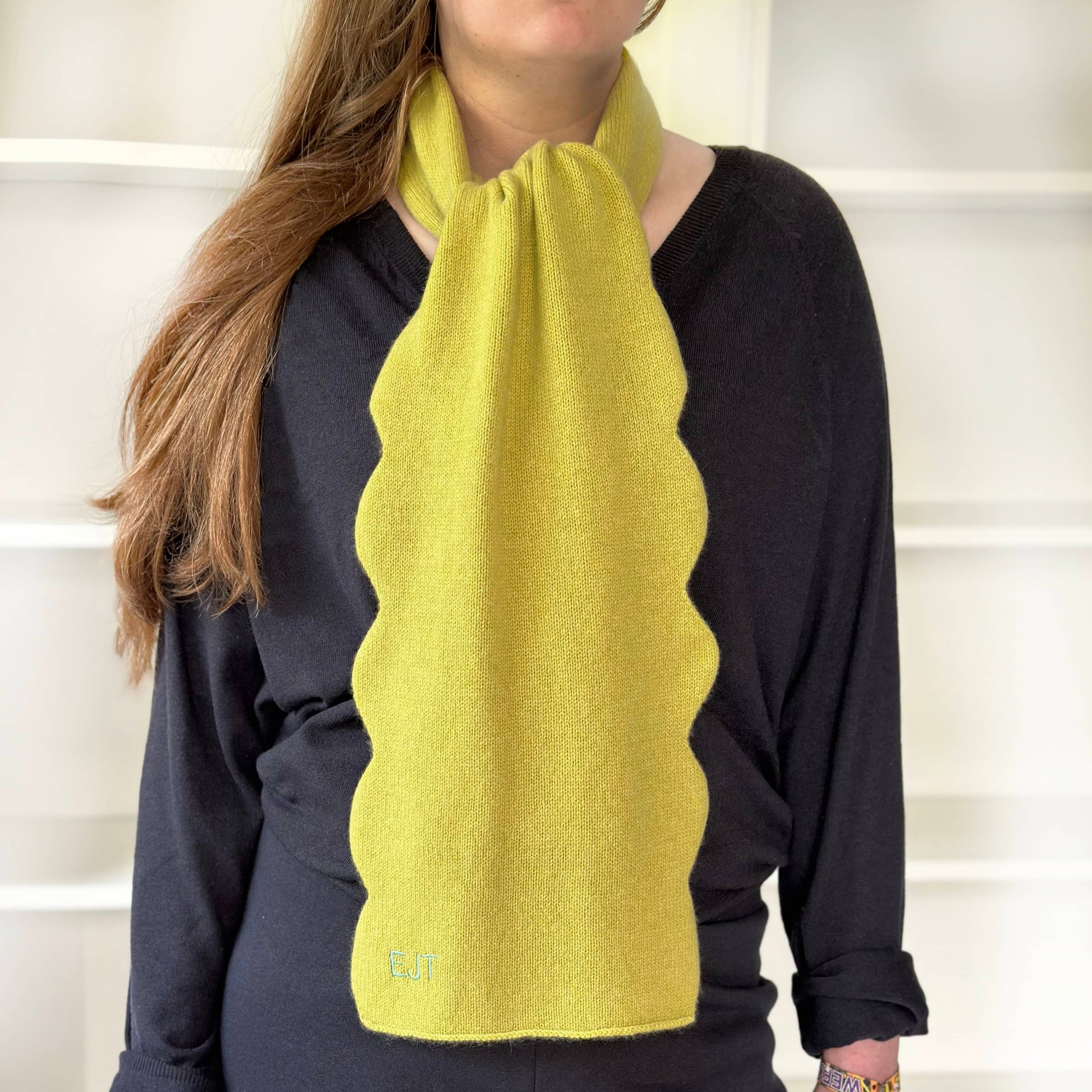 100% cashmere scarf by Cashmere Party.  With modern fun scalloped edge.  Handmade cashmere scarf with personalisation in Lime colour on woman.