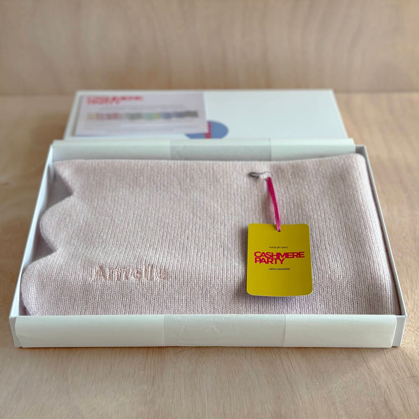 Pure cashmere new baby gift blanket with scallop edge folded in a gift box with branded swing ticket by Cashmere Party.